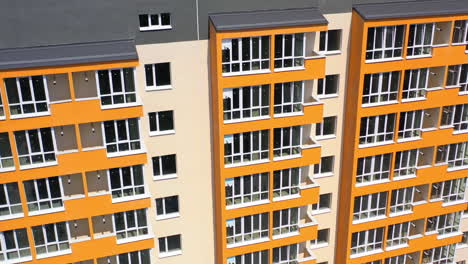 facade of newly built skyscraper. modern building with bright walls in the city. high raised building with large windows and balconies. front view.