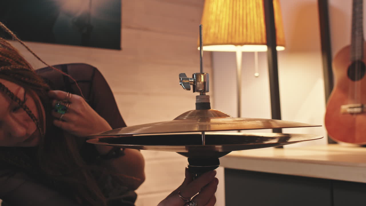 Woman Setting Up Drum Set Before Concert