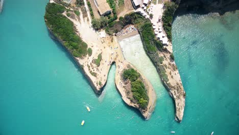 Aerial-top-down-rocky-cliff-beach-with-stunning-pristine-ocean-water-in-travel-holiday-destination-Greece-corfu-island-europe