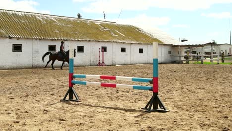 Woman Horseback Riding Over Jump