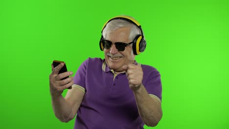 Elderly-stylish-caucasian-grandfather-man-using-social-media-app-on-smartphone