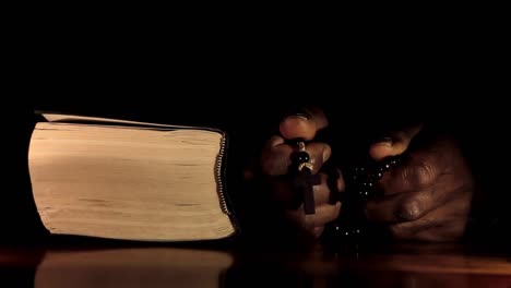 man-praying-to-god-with-hands-together-with-bible-Caribbean-man-praying-with-black-background-stock-video