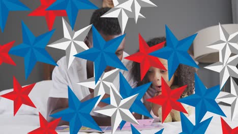 animation of red, blue and white stars over african american father and daughter having fun