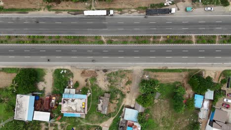 Highway-footage-with-a-focus-on-the-adjacent-service-road,-shows-the-local-traffic-and-connectivity-between-the-highway-and-surrounding-areas