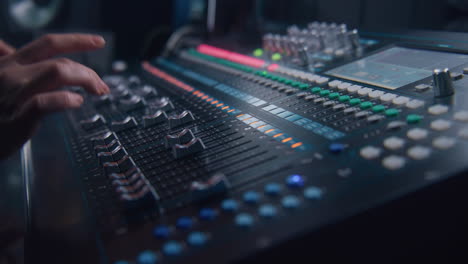 sound engineer uses audio mixer in recording studio