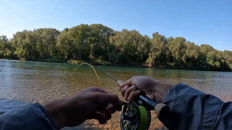 fly fishing on a clear river with casting action