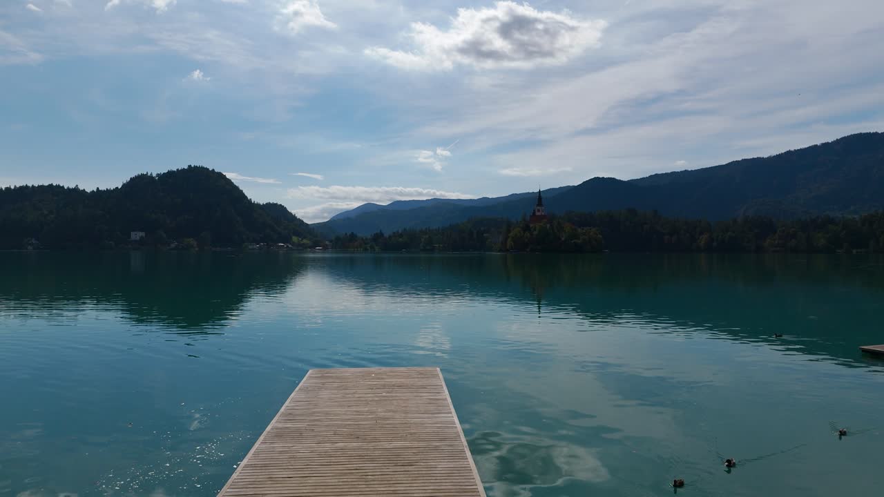 Pemandangan Panorama Dermaga Kayu di Danau Bled di Slovenia dengan Pegunungan di Cakrawala