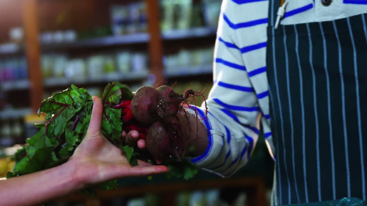Staff assisting woman in selecting fresh beetroots