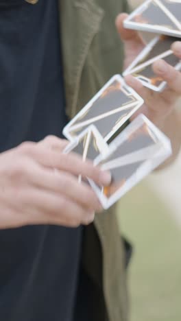 close-up of a person shuffling and handling yu-gi-oh! trading cards