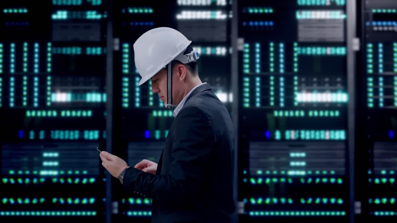 Side View of Asian Businessman Use Smartphone While Walking in Server Room Data Center