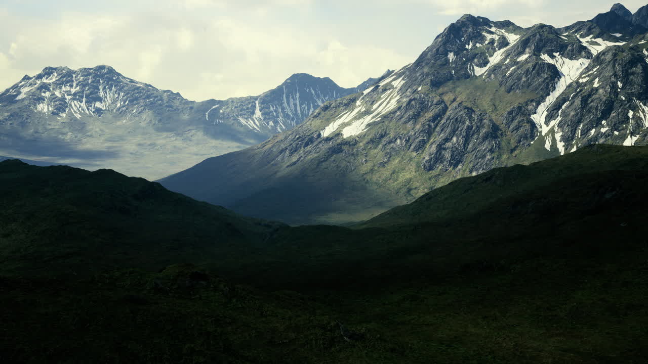 Majestic mountains rise above lush valleys in a scenic landscape