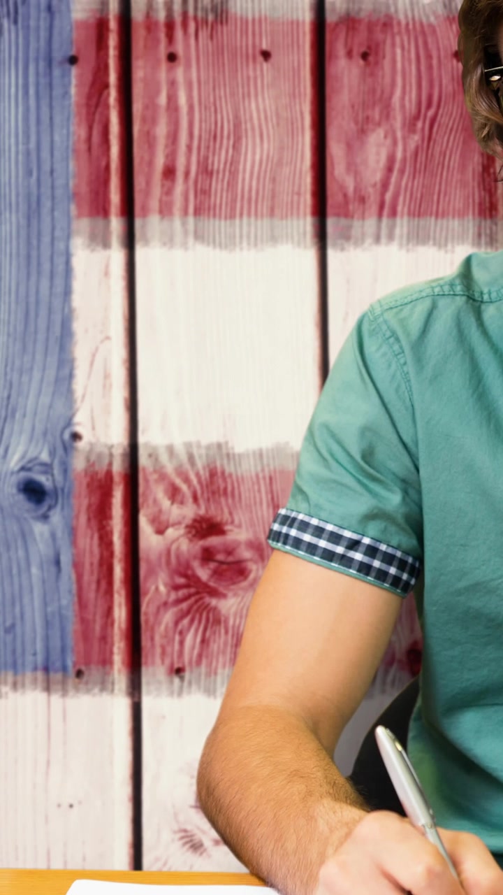 Animation of male student smiling over american flag