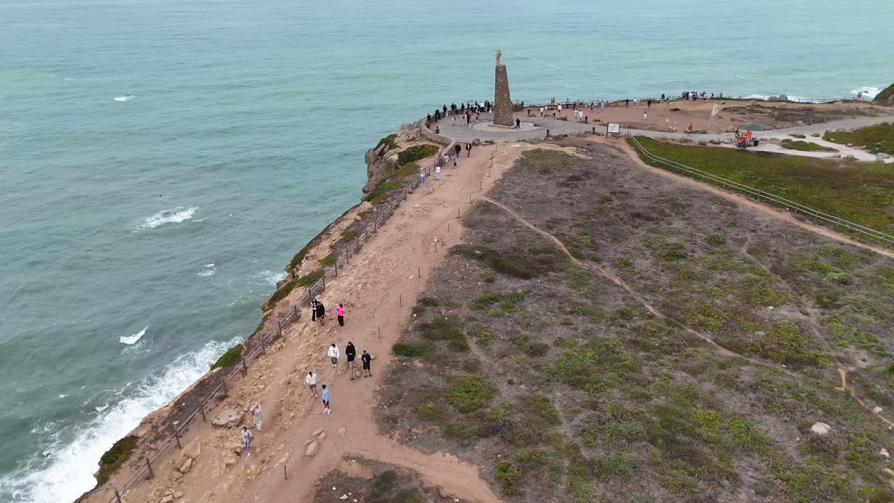 Scenic Coastal Cliff with Monument and People