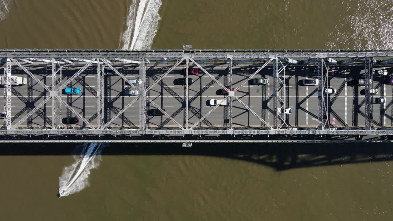 Jet skis passing under the Story Bridge a heritage-listed steel cantilever bridge spanning the Brisbane River. Aerial view