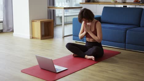 fitness coach teaching yoga online, greeting the group