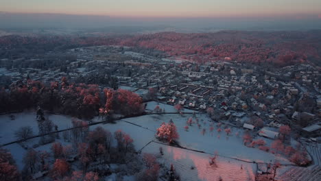Aerial-view-of-snowy-white-hills-during-a-red-sunrise