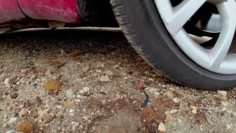 focused car wheel accelerating in slow motion on sandy ground