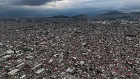 Drone Tilt‑Up shot over Ecatepec during a stormy afternoon in the CDMX metropolitan zone