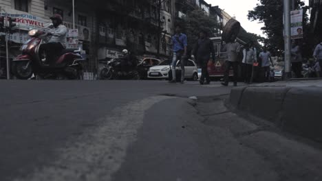 pedestrians and traffic from street level view india
