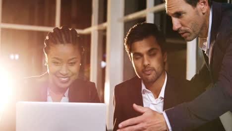 businessman discussing with colleagues over laptop