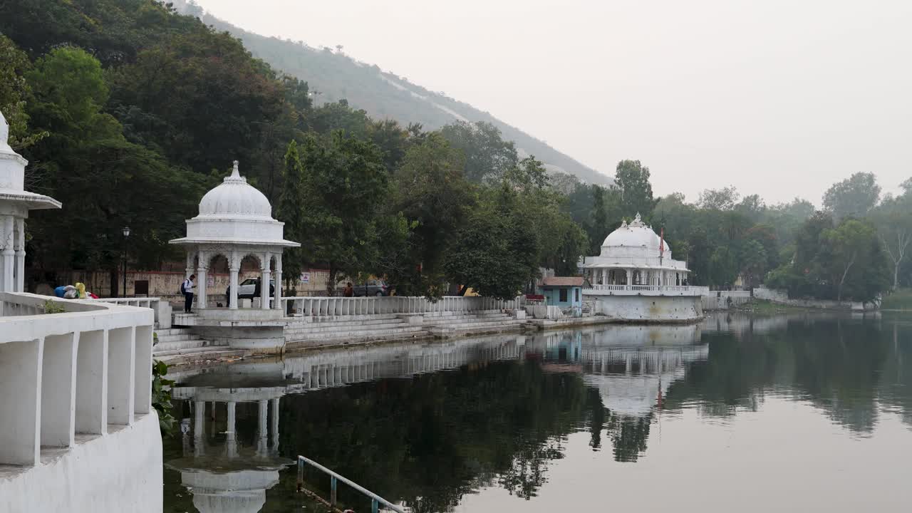 artistic city architecture with clam lake water reflection at morning video is taken at Udaipur rajasthan india on Nov 25 2023.