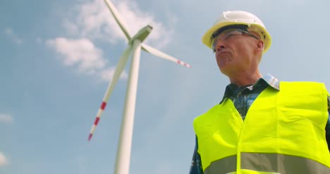 engineer writing on clipboard while doing wind turbine inspection 5