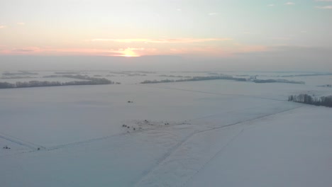 aerial view of the snow-covered plains of alberta during the sunset