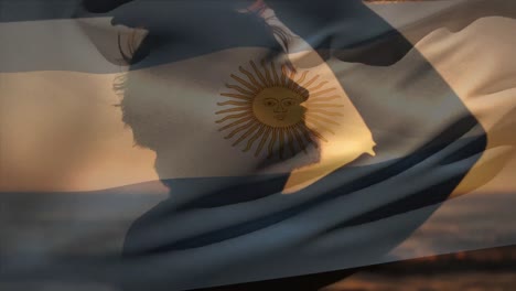 Animation-of-flag-of-argentina-over-caucasian-man-at-beach