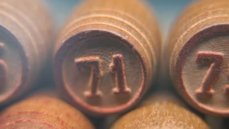 cinematic macro smooth shot of bingo wooden barrels in a row, woody figures, old numbers vintage board game, number 75, slow motion, commercial gimbal movement, pan right