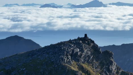 lonketinden's highest peak against bed of clouds in south senja, norway