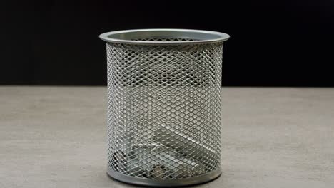 silver batteries aa and aaa falling into wastebasket close-up. double-a battery is a standard size single cell cylindrical dry battery. batteries are common in portable electronic devices. environmental impacts of lithium-ion batteries concept. an aa battery is composed of a single electrochemical c