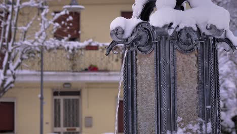 view of a water fountain in guardiagrele in winter with snow, abruzzo, italy