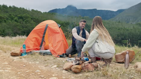 Couple,-outdoor-camping-and-pitch-tent-with-rock