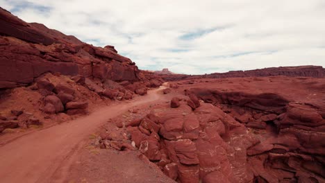 drone shot flying up an off road trail outside of moab, utah