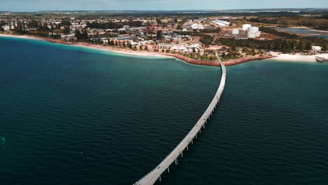 drone shot over the esperance jetty and the city esplanade on a sunny day with some clouds, western australia