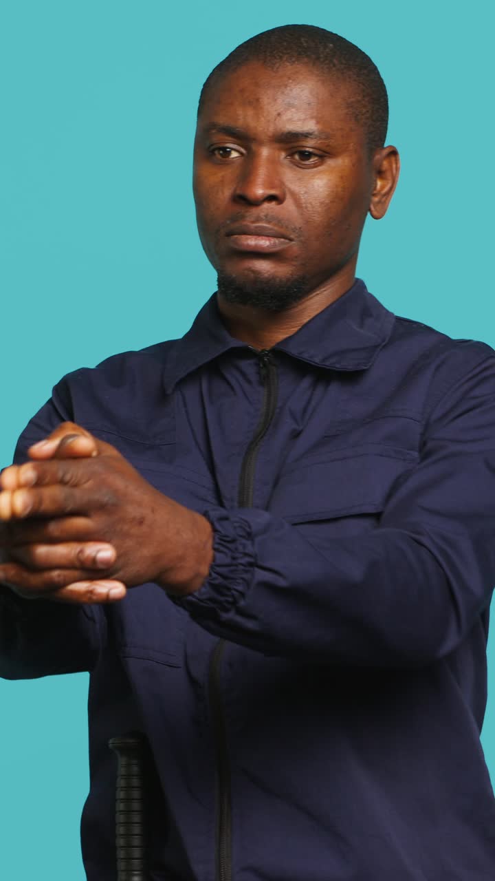 African American Man Rubbing Hands with Focused Expression
