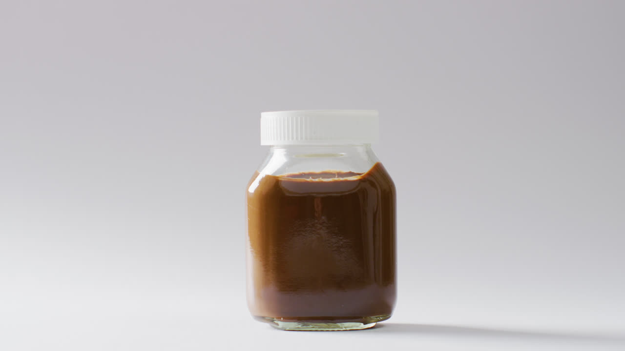 ⁇  배경 에 있는 초콜릿 크림 항아리 의 클로즈업 영상