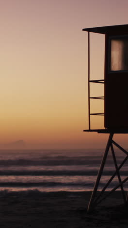 sea with waves and blue sky and lifeguard tower on beach