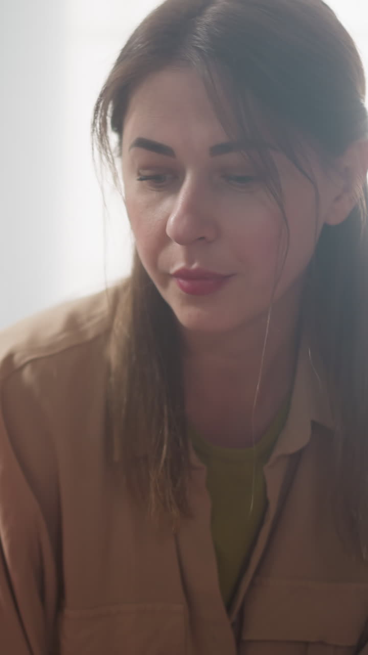 Concentrated mother and daughter look at boy sitting together in living room slow motion. Family education for little children. Woman with children