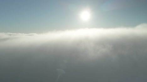 flying above the bright white clouds in the afternoon