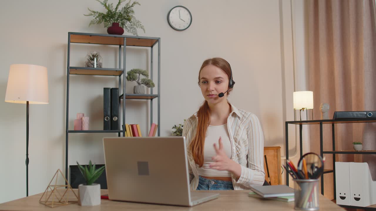 Mujer con auriculares usando computadora portátil hablando operadora de servicio de soporte al cliente en la oficina en casa