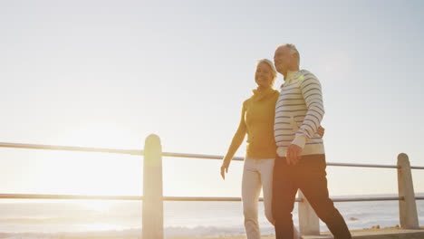 Senior-couple-walking-alongside-beach