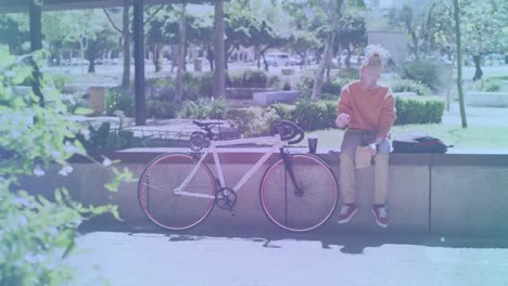 Animation-of-shapes-moving-over-albino-african-american-man-sitting-with-bicycle