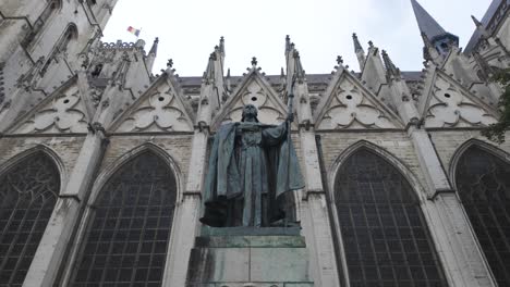 statue of cardinal mercier holding a staff, located in front of the majestic st. michael and st. gudula cathedral in brussels. pan up