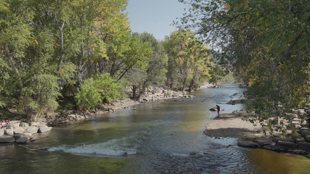 River Landscape with Trees and People
