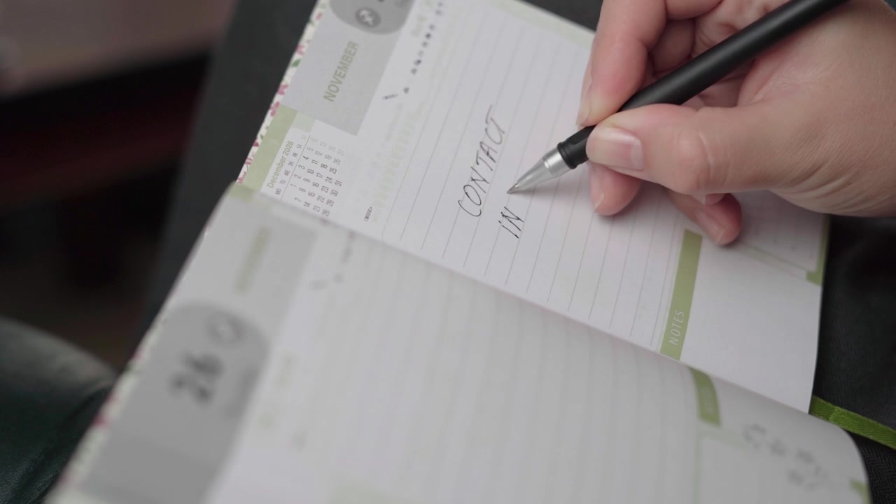Woman notes a task to contact her insurance provider about policy coverage in a November weekly planner.