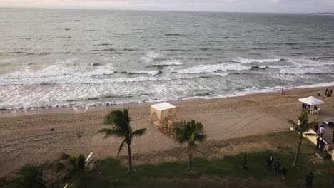 Aerial-view-of-the-setting-and-furnishings-for-a-beach-wedding-by-the-sea