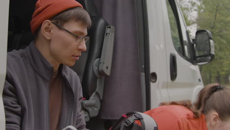 Heterosexual-couple-sitting-in-a-van