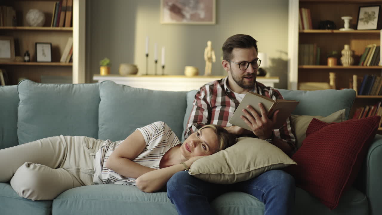 Couple relaxing and reading on the couch