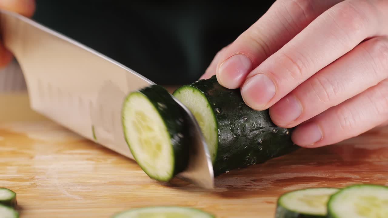 Slicing cucumber vegetables with a knife for cooking, chef cut vegetable.